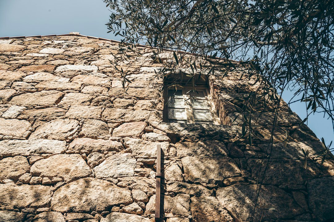 Abandoned stone building with broken windows