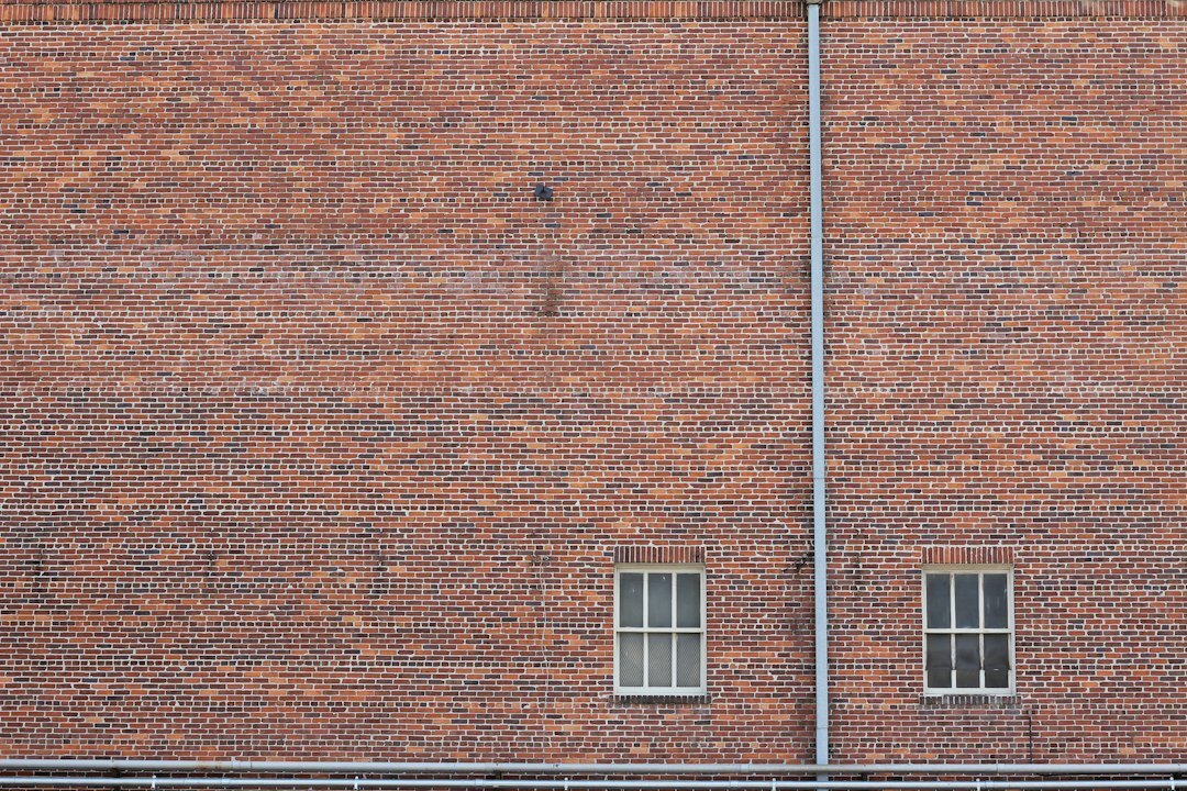 Weathered brick building facade with old windows
