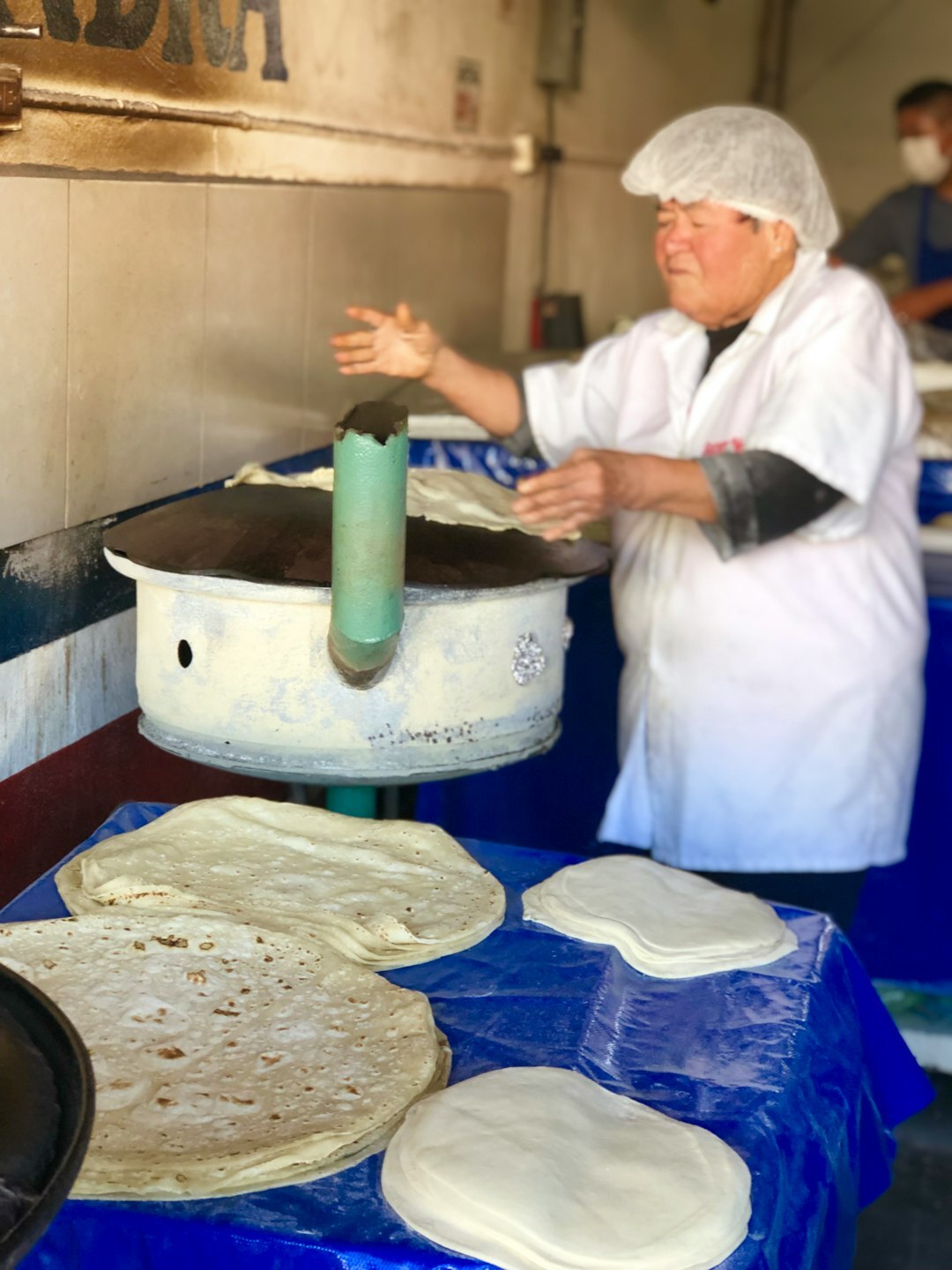 elderly woman cooking empanadas